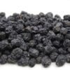Close-up of plump, dark purple dries aronia berries